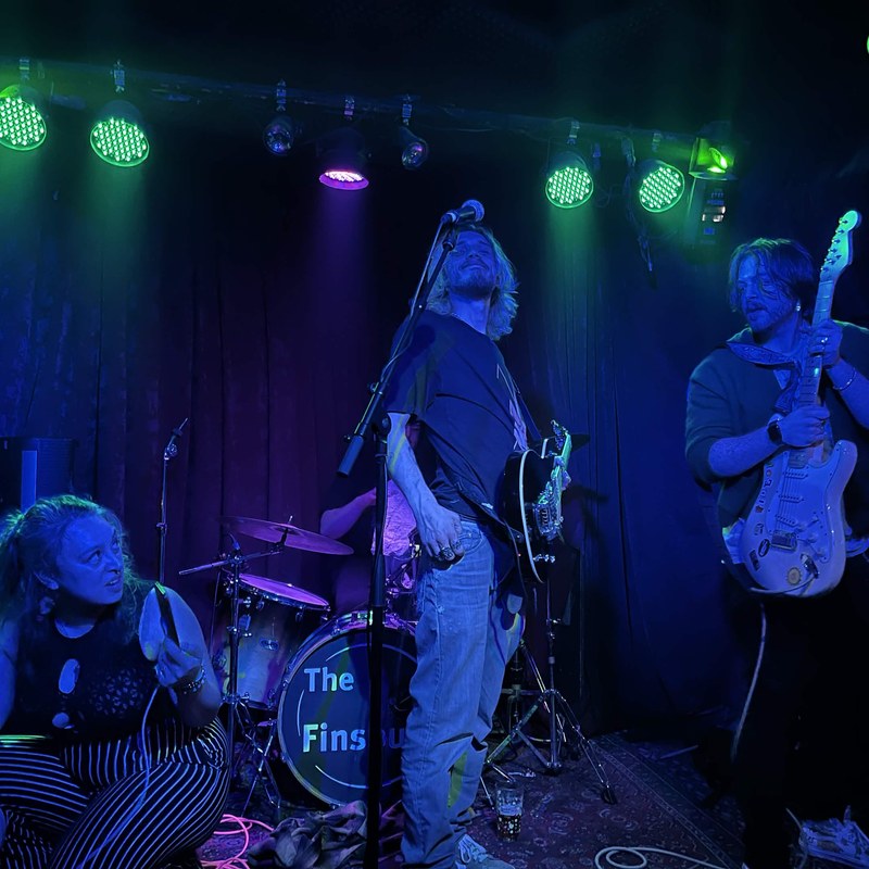 The band performing live on stage